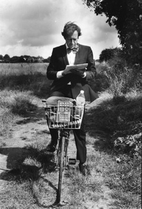 Miles on his bike reading a map